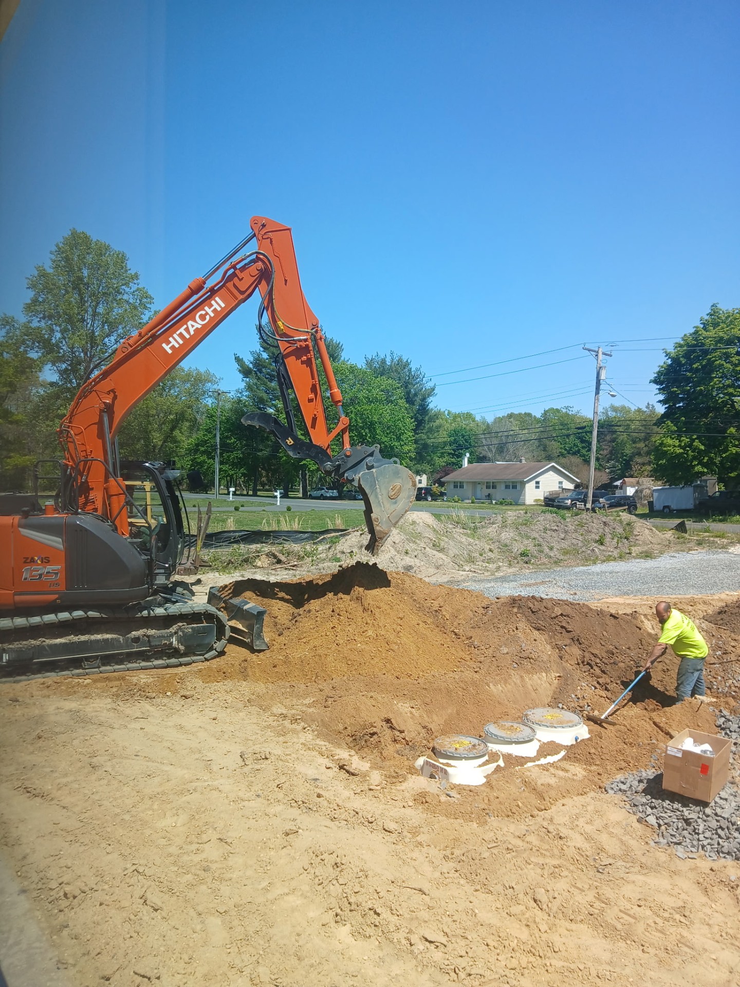 Hitachi excavator digging septic system on new build